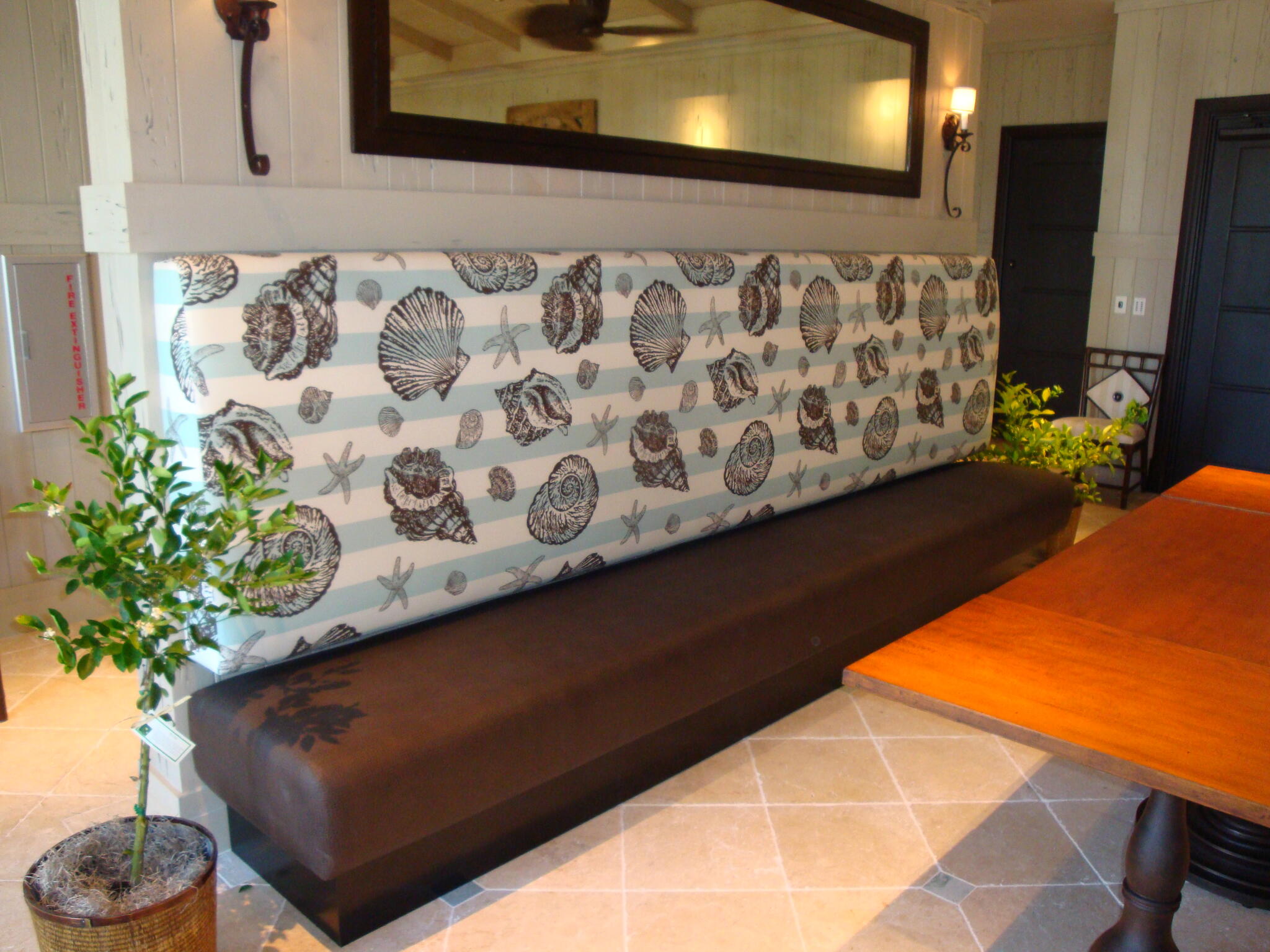 Shell-pattern upholstered bench back with a dark seat